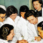 Student doctors hovering over child