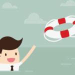 A man swimming in the ocean is tossed a life preserver.