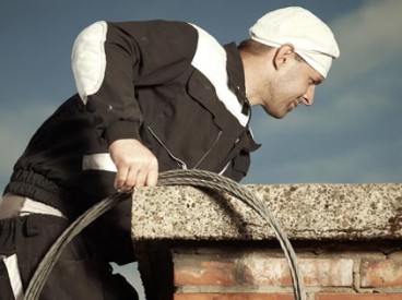 A chimney sweeper at work