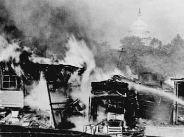 A Bonus Army encampment in Ancosta Fields is aflame after a confrontation with the U.S. military