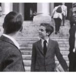 A boy speaking to college students.