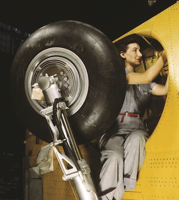 Woman mechanic working on a WW2 airplane