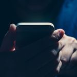 Hacker holding a phone