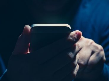Hacker holding a phone