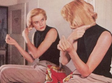 Grace Kelley in front of a mirror