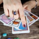 A fortune teller with a stack of tarot cards