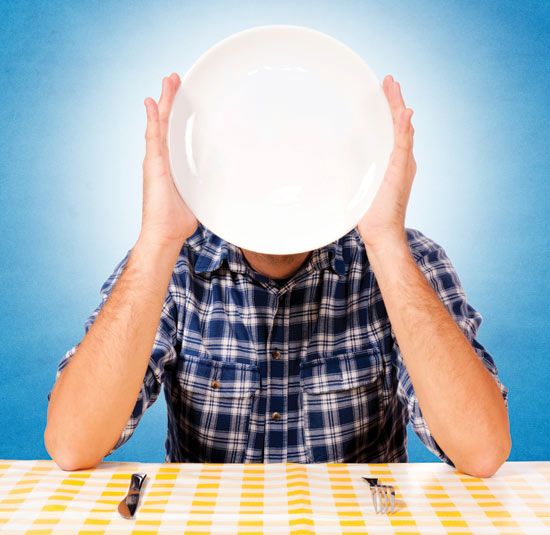 Man holding a plate in front of his face