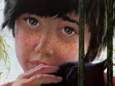 Close-up of a child behind bars