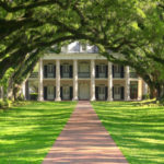 House at the end of a tree-lined path.