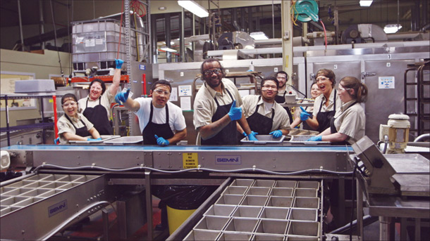 Crew members of Dave's Killer Bread pose for a group photo at the production line.