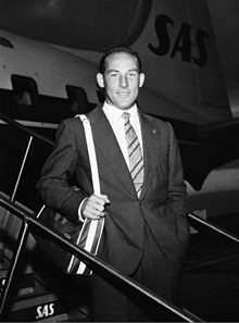 Photo of Stirling Moss disembarking a plane.