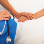 Doctor comforts a patient.
