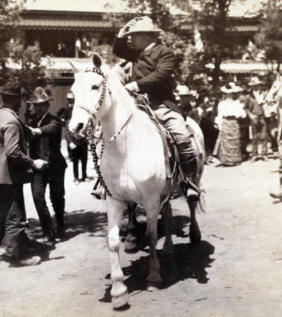 President Teddy Roosevelt riding on a horse