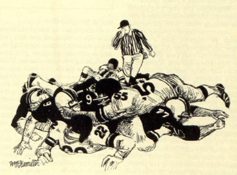 Two football players converse in a pile-up