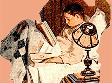 Boy Reading in bed.