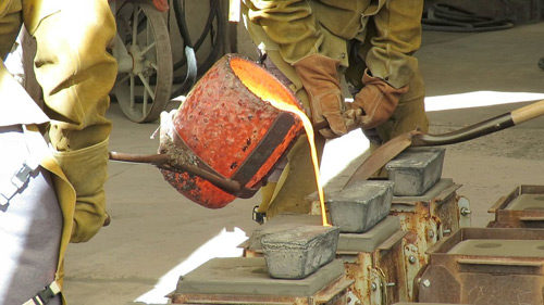 Molton glass being poured into a mold.
