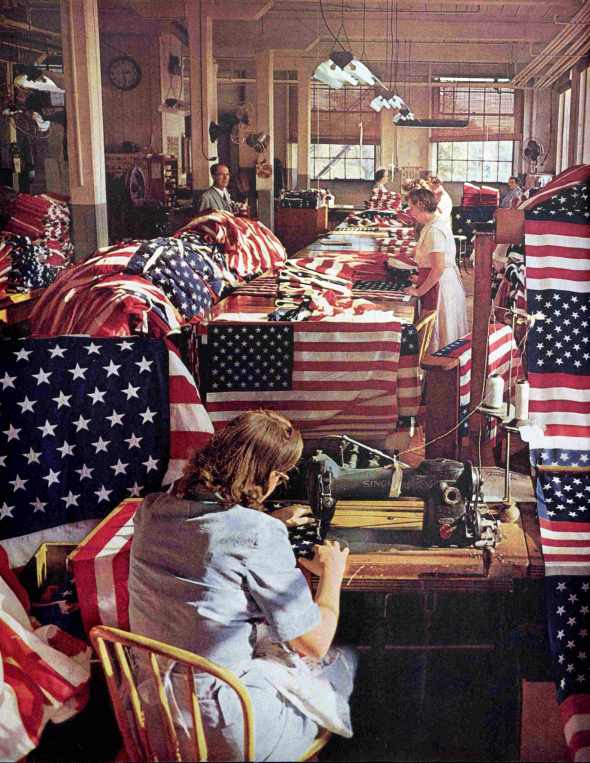 People Sewing 50 Stars on US Flag