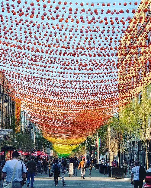 Mulit-color balls hang over the street in Montreal's Gay Village