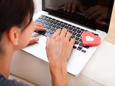 A woman works on her online dating profile