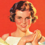 Woman standing behind Valentine boxes of chocolates and flowers