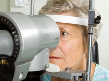 A woman having her eyes checked for Age-Related Macular Degeneration.