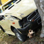 Car that has crashed into a tree.