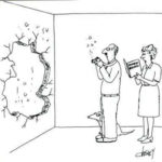 A confused man with a camera is standing in front of a huge hole in his living room wall. His wife is standing next to him, reading aloud the camera's instruction manual.