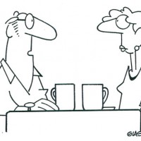 An older couple talk over coffee.