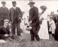 John Moisant, 1868-1910 (Greeted after his cross-channel flight with an English picnic.)