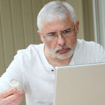 A man is researching his medication online.