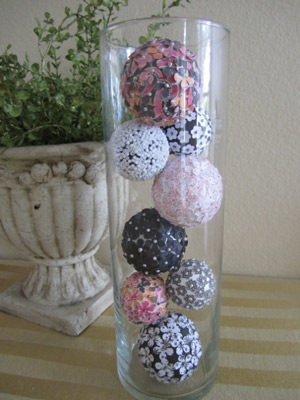 paper and bead ball ornaments in glass vase
