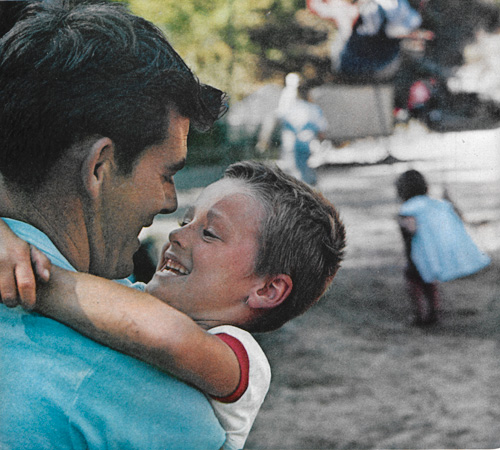 Still new to love as well as life, the child is nevertheless adept.  He opens himself to love completely, and we are awed.  Photo by Wayne Miller.