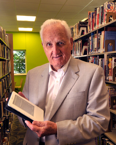 photo_earl_conn_kindle "The Kindle’s features go beyond what any book can do," says Dr. Earl Conn, "providing an Internet connection at your finger tips while you’re reading."<br />Photo © Dale Pickett