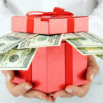 hands holding money in a box