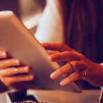 Woman Using Tablet on a Train
