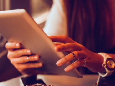 Woman Using Tablet on a Train