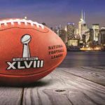 Football with the Super Bowl XVIII logo in front of the New York City skyline