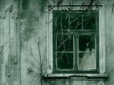 Spooky girl in window