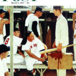 Boy in civilian clothes walks into baseball locker room