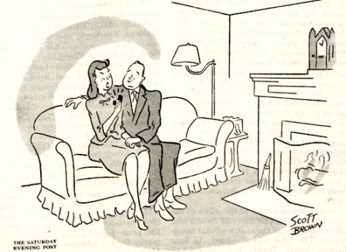 A woman and her boyfriend sit on a sofa. She is holding a diamond ring.