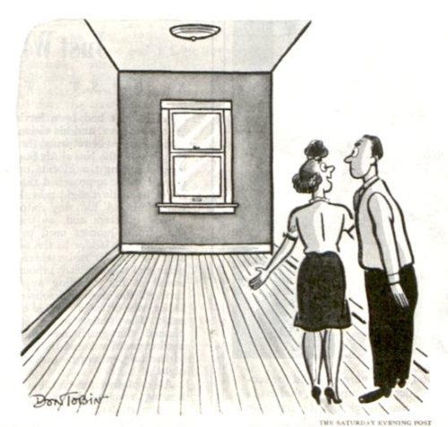 A woman is talking to her surprised husband in an empty room.
