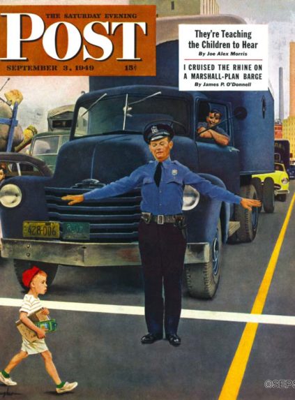 Policeman stopping traffic for schoolboy
