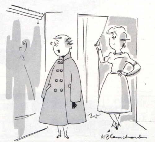 Woman trying on coats in a department store's dressing room