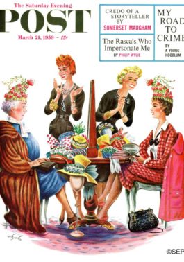 Two women wearing a very ridiculous hat