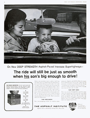 Boy in front seat of car holding plastic steering wheel