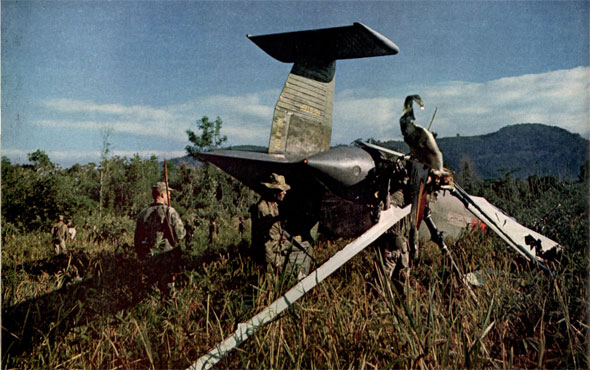 "The end of Marion Spook. It's engine gave out 700 yards from Buon Mi Ga, but nobody was hurt. Abernathy (left) and Vaughn guard the wreckage."