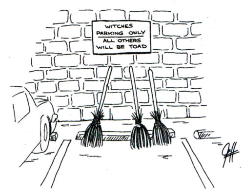 Witches' brooms rest on a brick wall as they occupy a parking space. Sign above the brooms reads "Witches Parking Only. Others Will Be Toad"