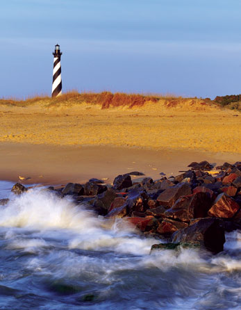 A lighthouse near a beach.