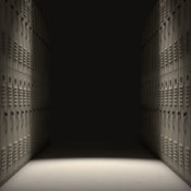 A direct top view of a row of regular school lockers in a corridor dramatically lit by a single spotlight