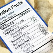 Nutrition label in a pile of salty potato chips